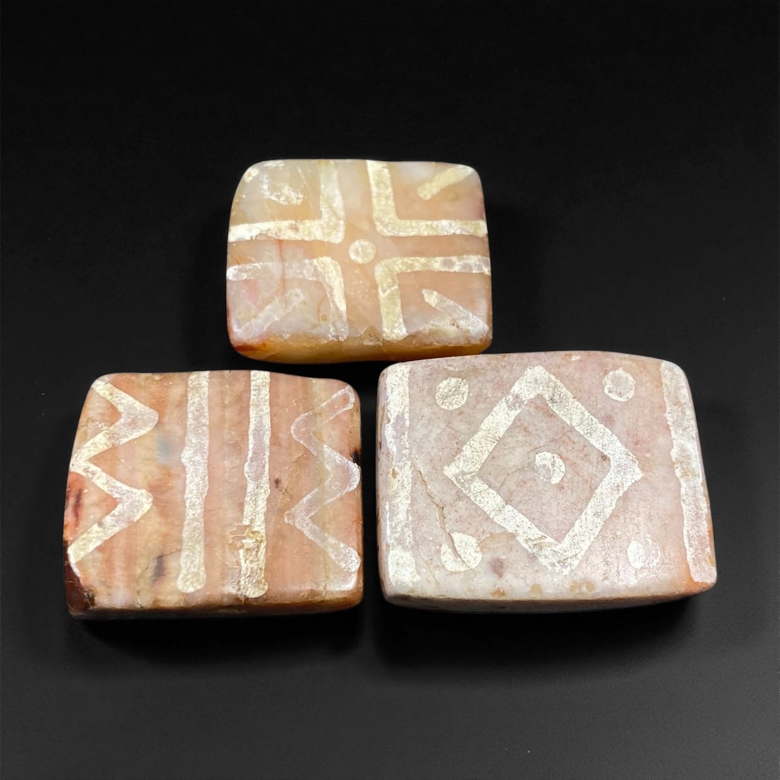 Ancient Medieval Silk Road Indo-Himalayan Etched Carnelian Beads, c. 8th-12th Century CE, 2.4-2.8cm: This elegant set of three etched carnelian beads originates from the Indo-Himalayan regions that flourished along the ancient Silk Road between the 8th and 12th centuries CE. Crafted from semi-translu