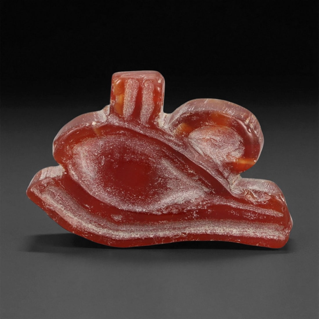 Ancient Egyptian Carnelian Wadjet Eye (Eye of Horus) Amulet, New Kingdom, c. 1550-1070 BCE, 4.5cm: This beautifully carved amulet, crafted from translucent deep red carnelian, represents the Wadjet Eye-the sacred Eye of Horus, symbolizing protection, healing, and divine restoration. Dating to Egypt