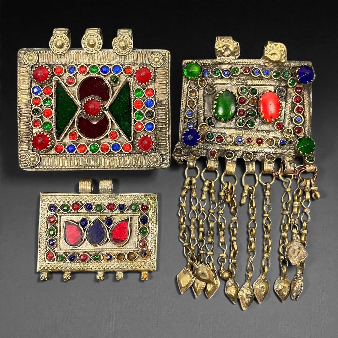 Antique Himalayan Silver Alloy Amulet Box Pendants Set, c. 19th-20th Century, 5.7-7.4 cm: This captivating set of 3 antique Himalayan amulet boxes, dating to the 19th-20th century, represents the region's deep spiritual and artistic heritage. Crafted in silver alloy and richly adorned with