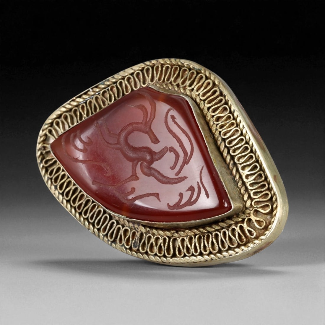 Antique Central Asian Silver Ring with Engraved Carnelian, c. 19th-20th Century, 31g: This commanding antique silver ring showcases the enduring Central Asian tradition of carnelian intaglios, a practice with roots stretching back to Persian and Islamic craftsmanship. The bezel holds a