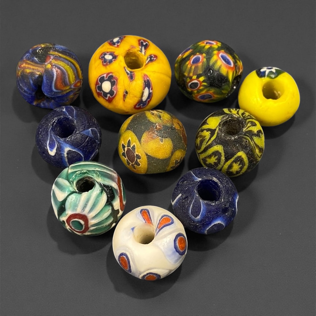 Antique Venetian Polychrome Millefiori and Chevron Glass Beads, c. 19th Century, 1.4-2cm: This lively assemblage of antique Venetian glass beads, dating from the 19th century, captures the exuberant color and artistry that made Murano glassmakers the undisputed masters of decorative beadwo