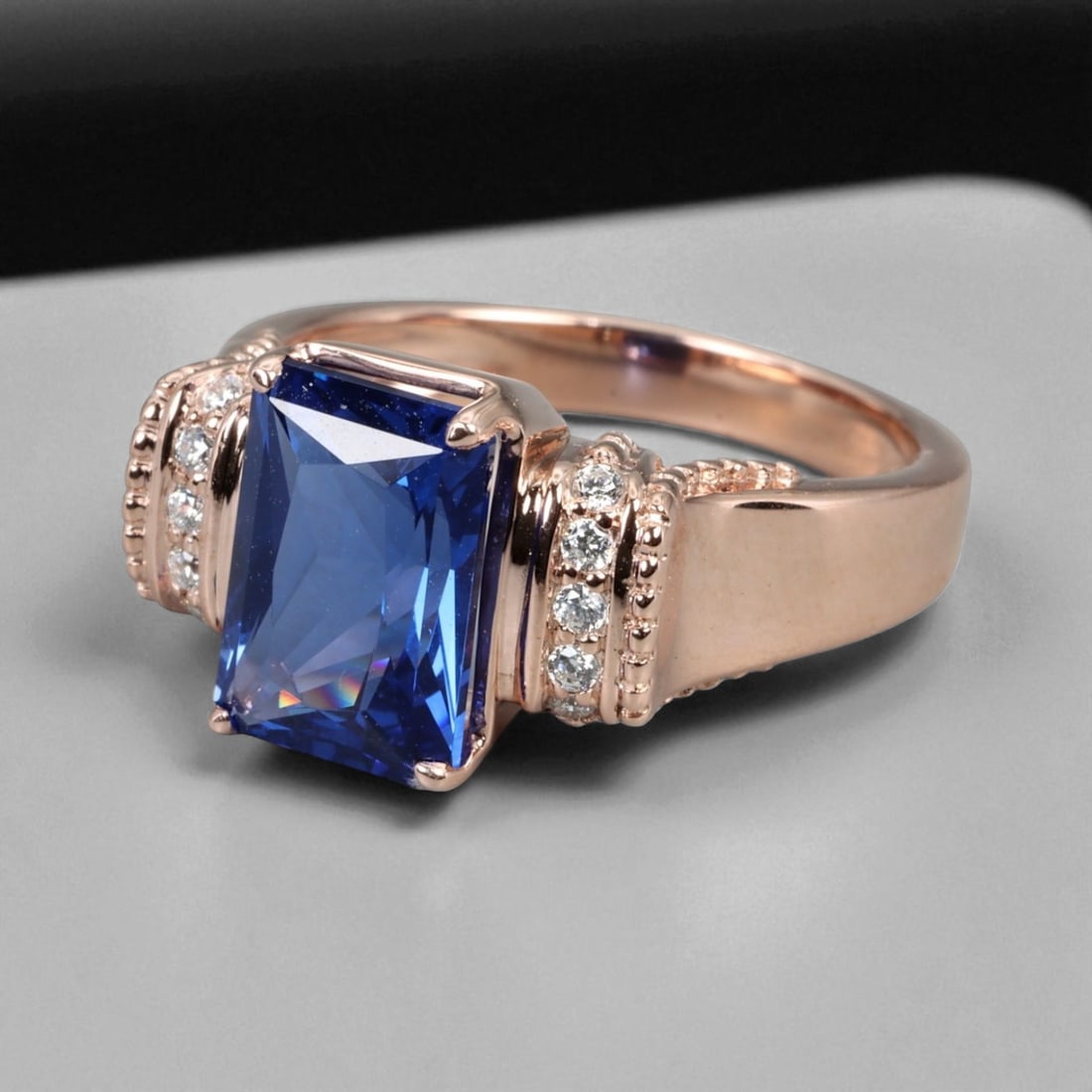 Chatham Blue Sapphire Imperial Bead Pattern 925 Silver Ring, 7.5 US: This regal 925 silver ring presents the Imperial Bead pattern - a design defined by its architectural symmetry and refined detail. The centerpiece is a rectangular Chatham blue sapphire, radiating a c