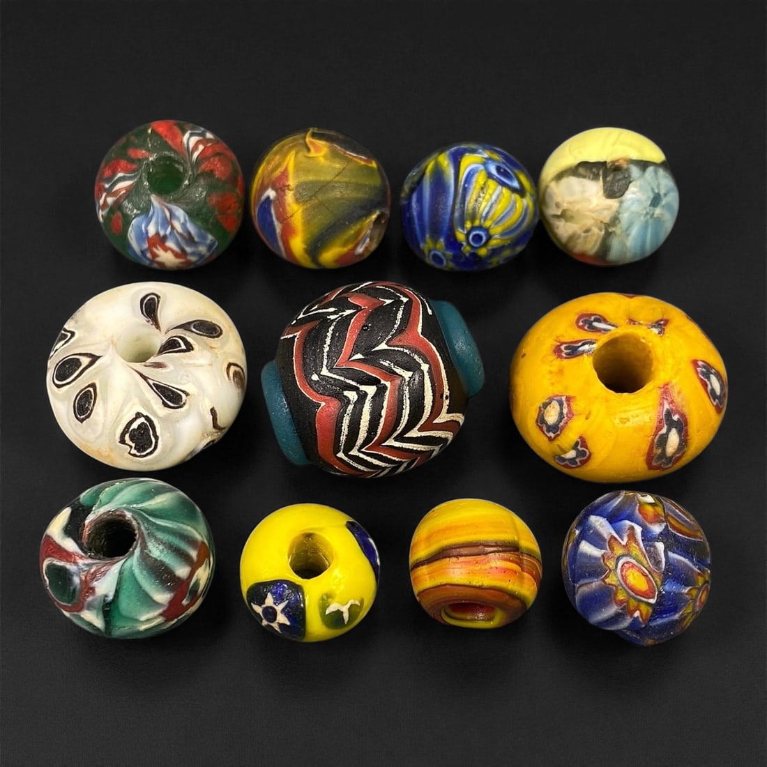 Antique Venetian Polychrome Millefiori and Chevron Glass Beads, c. 19th Century, 1.4-2.3cm: This lively assemblage of antique Venetian glass beads, dating from the 19th century, captures the exuberant color and artistry that made Murano glassmakers the undisputed masters of decorative beadwo