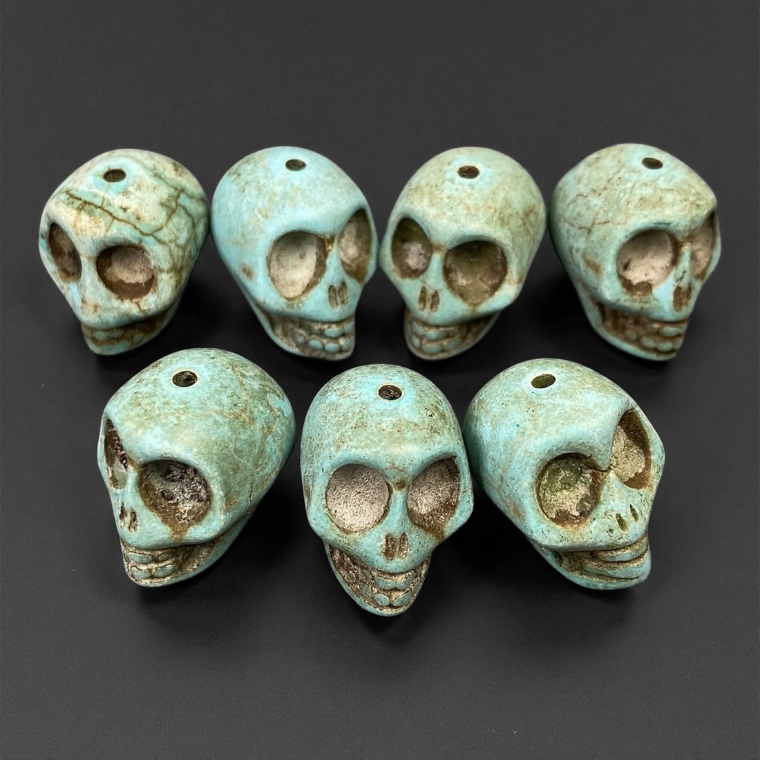 Vintage Tibetan Turquoise Skull Beads, Set of Four, c. Mid-20th Century, 1.7-1.8cm: This striking set of turquoise-carved skull beads, originates from Tibet and dates to the mid-20th century. Finely shaped and perforated for stringing, each bead represents a human skull, a motif rich