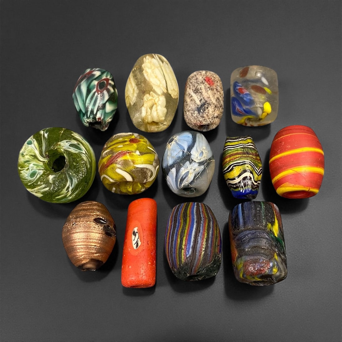 Antique Venetian Polychrome Millefiori and Chevron Glass Beads, c. 19th Century, 1.6-2.5cm: This lively assemblage of antique Venetian glass beads, dating from the 19th century, captures the exuberant color and artistry that made Murano glassmakers the undisputed masters of decorative beadwo