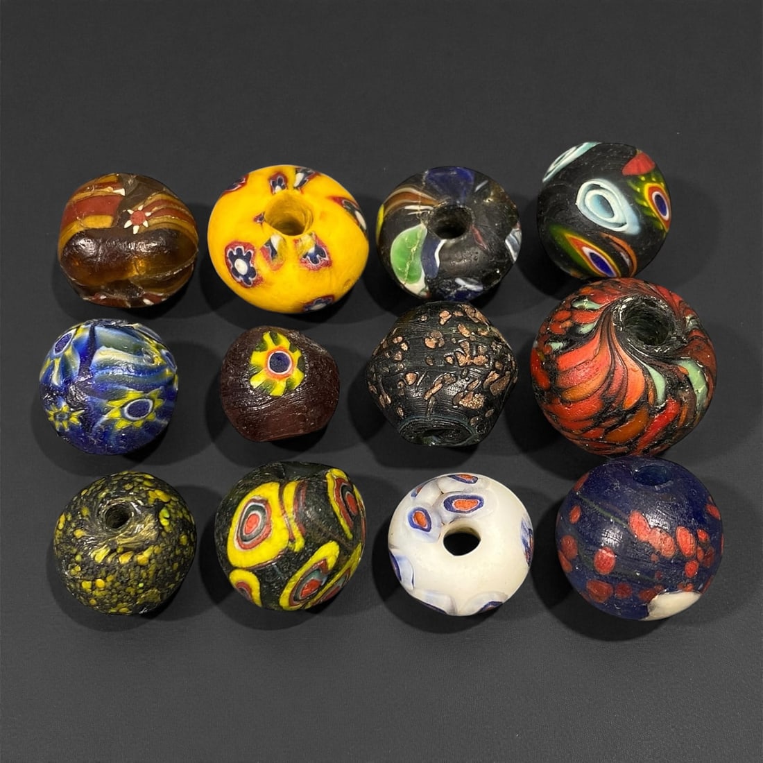Antique Venetian Polychrome Millefiori and Chevron Glass Beads, c. 19th Century, 1.4-2.1cm: This lively assemblage of antique Venetian glass beads, dating from the 19th century, captures the exuberant color and artistry that made Murano glassmakers the undisputed masters of decorative beadwo