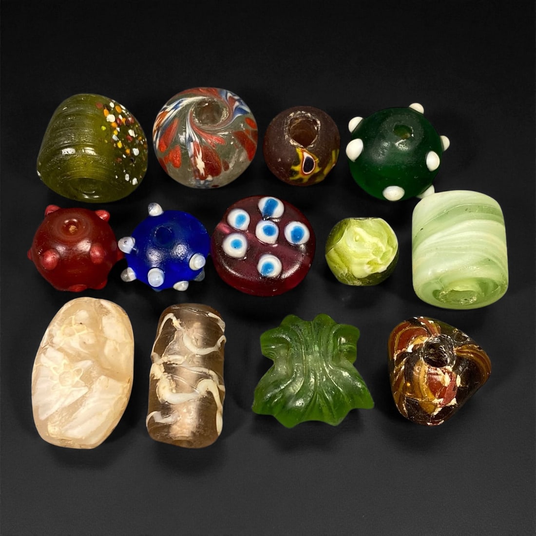 Antique Venetian Polychrome Millefiori and Chevron Glass Beads, c. 19th Century, 1.2-2.2cm: This lively assemblage of antique Venetian glass beads, dating from the 19th century, captures the exuberant color and artistry that made Murano glassmakers the undisputed masters of decorative beadwo