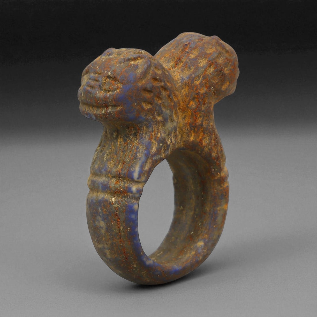 Ancient Parthian Double-Head Lapis Lazuli Ring, c. 2nd-1st Century BCE, 4 cm: This remarkable ring, sculpted from vibrant lapis lazuli, represents the artistic refinement and spiritual symbolism of the Parthian Empire. The dual-headed motif, emerging from the shoulders of the r