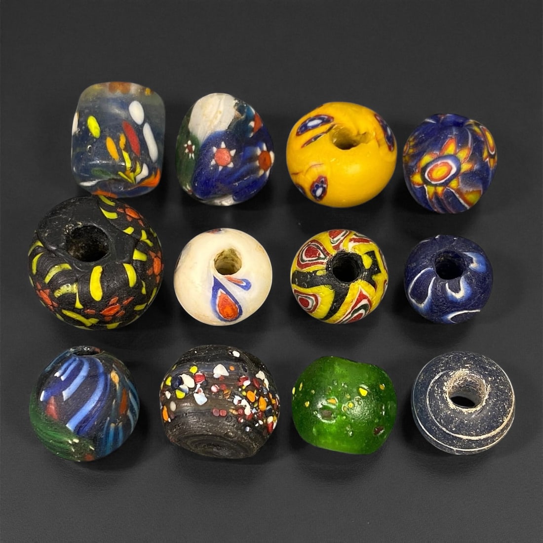 Antique Venetian Polychrome Millefiori and Chevron Glass Beads, c. 19th Century, 1.4-2cm: This lively assemblage of antique Venetian glass beads, dating from the 19th century, captures the exuberant color and artistry that made Murano glassmakers the undisputed masters of decorative beadwo