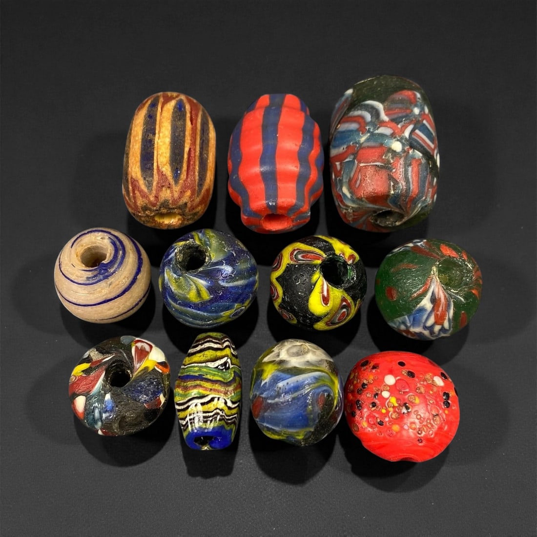 Antique Venetian Polychrome Millefiori and Chevron Glass Beads, c. 19th Century, 1.7-2.4cm: This lively assemblage of antique Venetian glass beads, dating from the 19th century, captures the exuberant color and artistry that made Murano glassmakers the undisputed masters of decorative beadwo