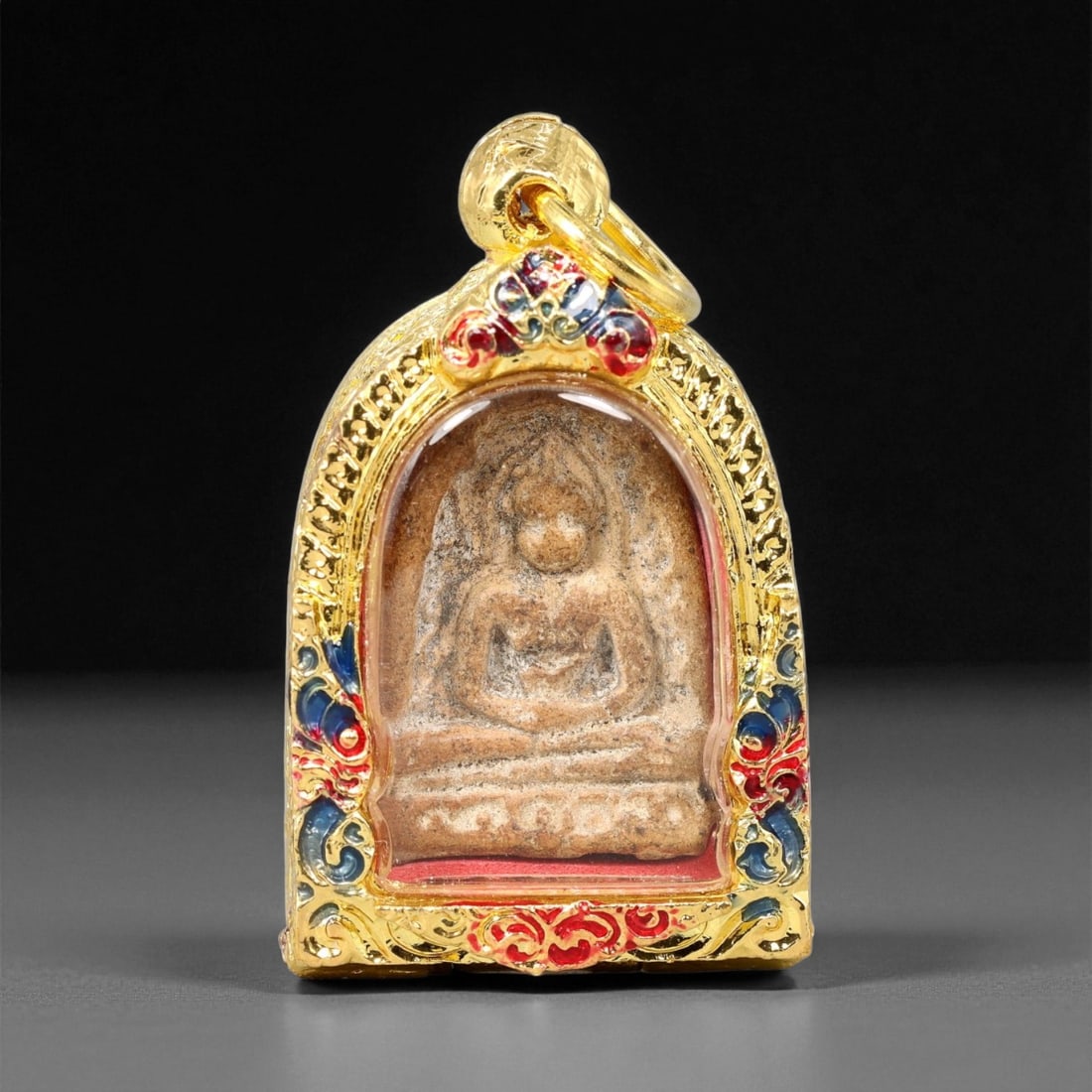 Gilt Buddhist Amulet in Ornate Gold-Tone Frame, Thai Temple Style , 4.5cm: This beautifully crafted gilt Buddhist amulet is enclosed within an intricately designed gold-tone frame, combining sacred symbolism with refined artistry. The detailed relief and lustrous finish refl