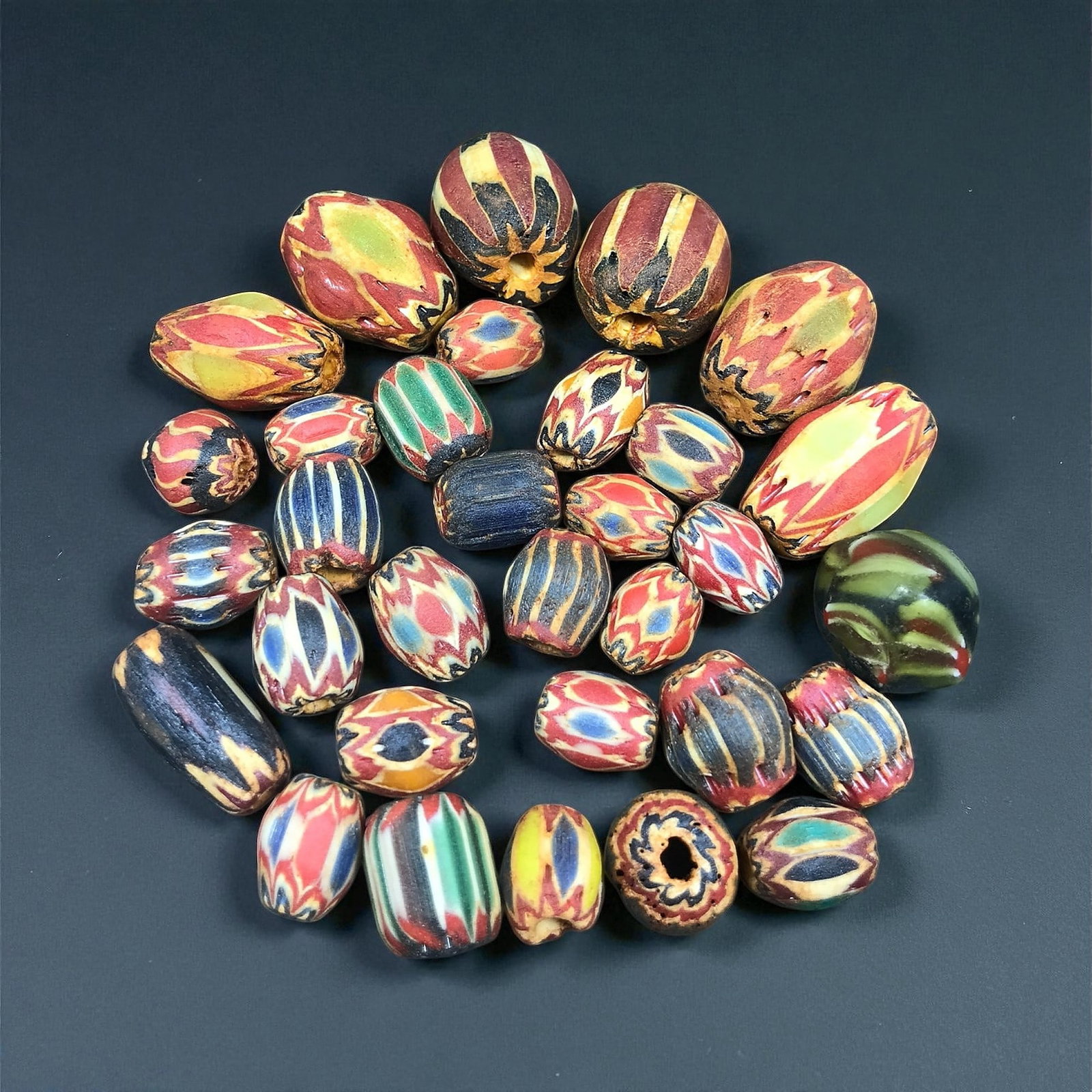 Antique Venetian Chevron Glass Trade Bead Set, c. 19th Century, 1.2-2.3 cm: This antique set of Venetian chevron beads represents one of the most iconic glassmaking traditions of 19th century Europe. Produced in the glasshouses of Venice, these beads were crafted using the la