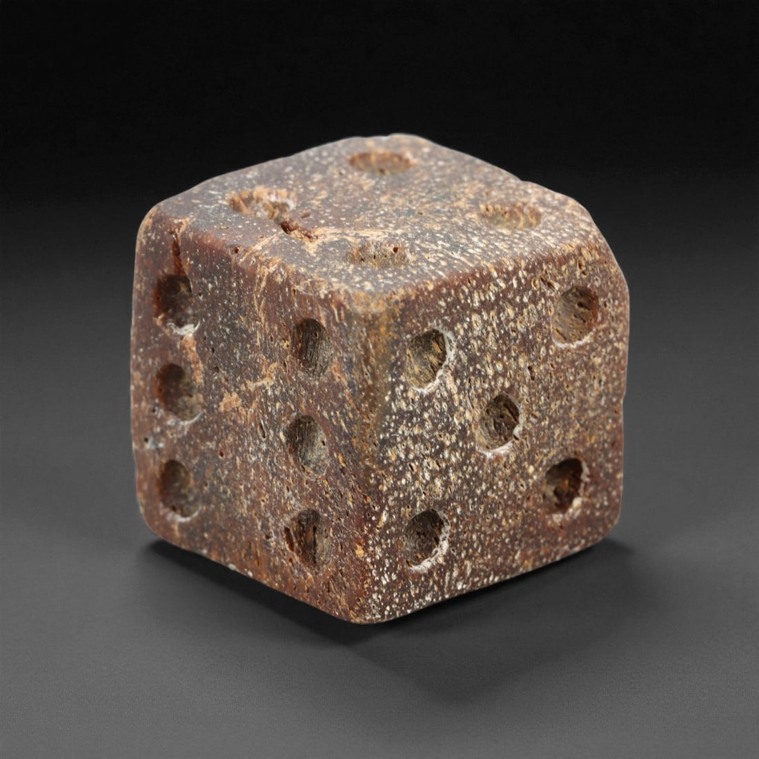 Ancient Roman Gaming Bone Dice, c. 1st-3rd Century CE 1.7cm, 2ES: This ancient Roman gaming die, carved from dense bone, reflects the enduring spirit of play and strategy within Roman daily life. Dice like this were used in taverns, private homes, and military encam