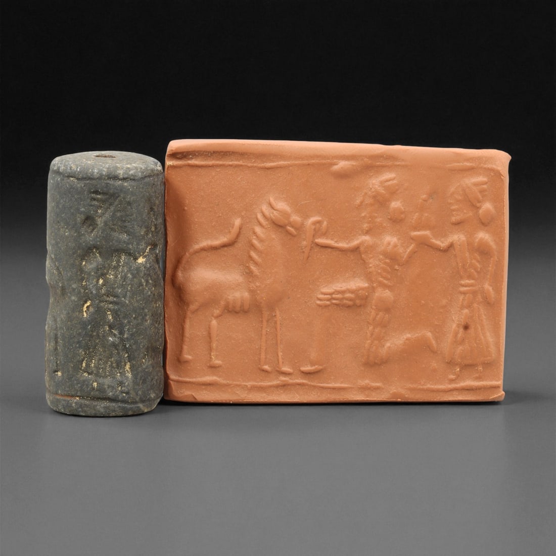 Ancient Mesopotamian Akkadian Steatite Cylinder Seal, c. 2300-2100 BCE, 4.2cm, 8EV: Carved from fine dark steatite, this ancient Akkadian cylinder seal dates to the late 3rd millennium BCE, a period when Mesopotamian artisans perfected the art of miniature relief engraving. Each seal