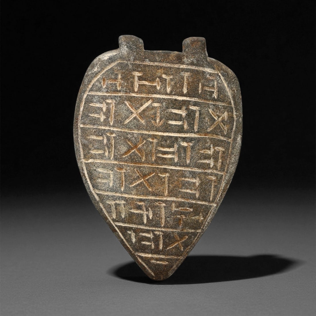 Ancient Mesopotamian Inscribed Serpentine Amulet, c. Neo-Assyrian Period, 6.7cm, 53ES: This elegant serpentine amulet, inscribed with precise cuneiform script, dates to the Neo-Assyrian period (circa 9th-7th century BCE). Objects of this kind were believed to embody sacred protection, t