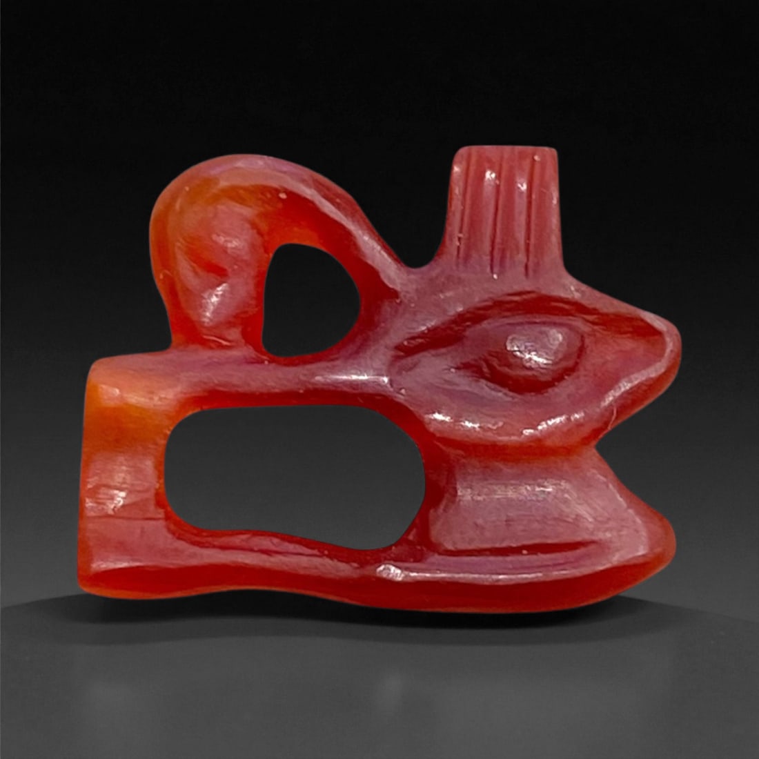 Ancient Egyptian Carnelian Wedjat Eye Amulet, c. Late Period, 7th-4th Century BCE, 1.5cm, 0.7g, 90AA: This delicate carnelian amulet represents the Wedjat or Eye of Horus, one of the most enduring and powerful symbols in ancient Egyptian religion. The Wedjat was believed to embody healing, protection,