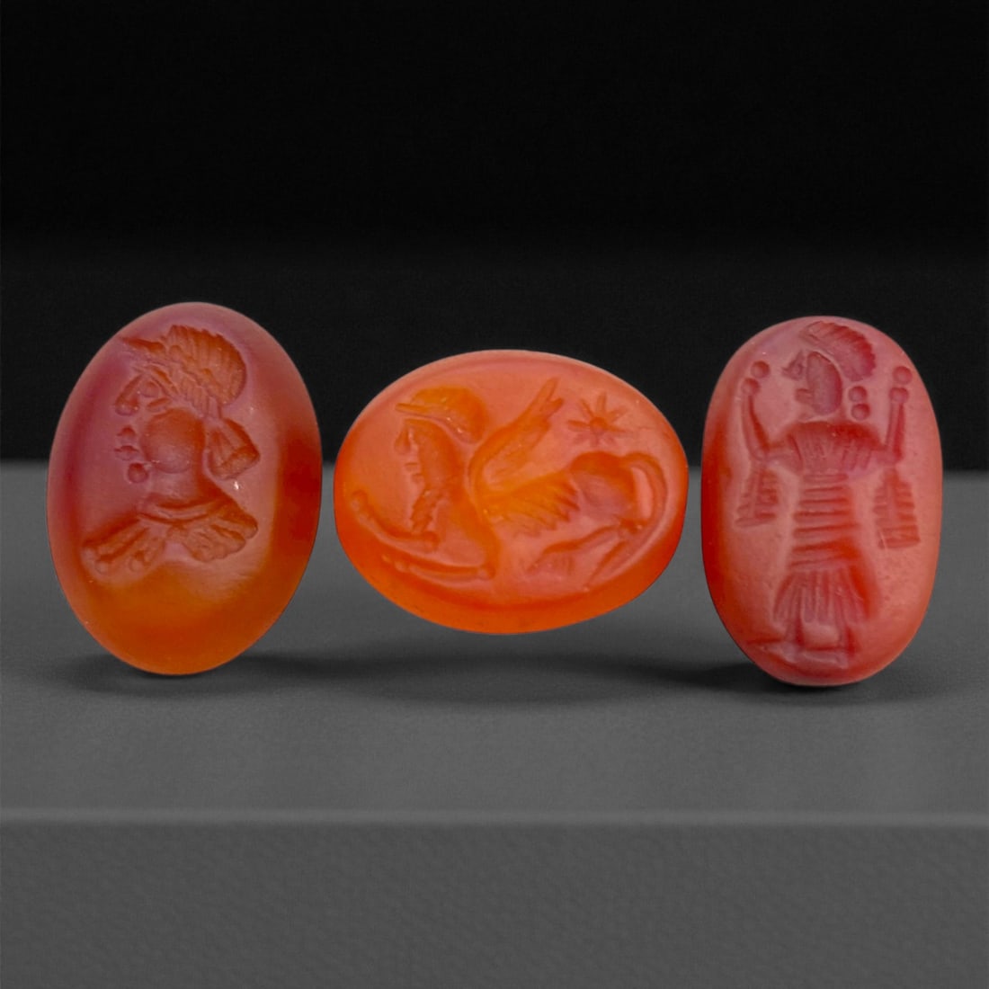 Ancient Sasanian Carnelian Intaglio Seals, c. 3rd-6th Century CE, 1.5 cm, 7 g, 6DD: This elegant trio of engraved carnelian intaglio seals dates to the Sasanian Empire, a golden age of Persian artistry and spiritual symbolism. Each gem is masterfully carved with fine intaglio detail 