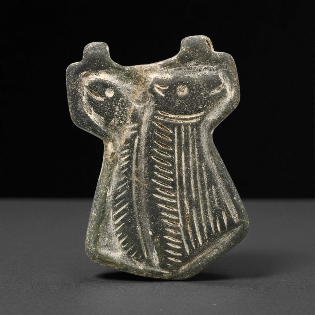 A Early Dynastic Mesopotamian Twin Fish Motif Steatite Amulet, c. 26th-24th Century BCE, 5.2cm, 80ET: This exceptional steatite amulet from the Early Dynastic period of Mesopotamia presents a rare and symbolic depiction of twin fish-an image representing abundance, fertility, and divine harmony within