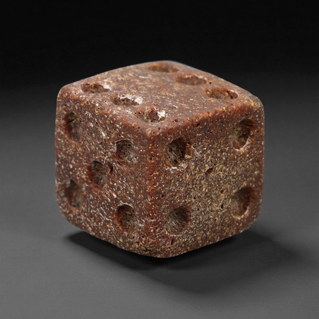 Ancient Roman Gaming Bone Dice, c. 1st-3rd Century CE 1.5cm, 52ES: This ancient Roman gaming die, carved from dense bone, reflects the enduring spirit of play and strategy within Roman daily life. Dice like this were used in taverns, private homes, and military encam