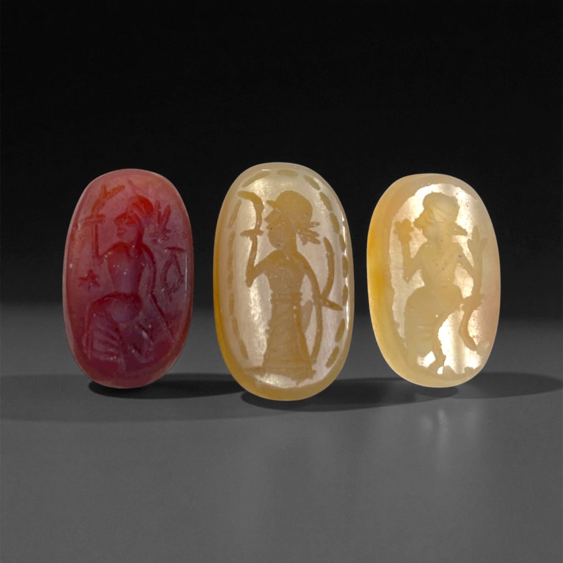 Ancient Sasanian Chalcedony and Carnelian Intaglio Group, c. 3rd-6th Century CE, 2-2.5cm, 8g, 38DD: This distinguished trio of Sasanian intaglios captures the refined artistry and spiritual symbolism of Persia's last great pre-Islamic empire. Dating to the 3rd-6th century CE, these finely engraved s