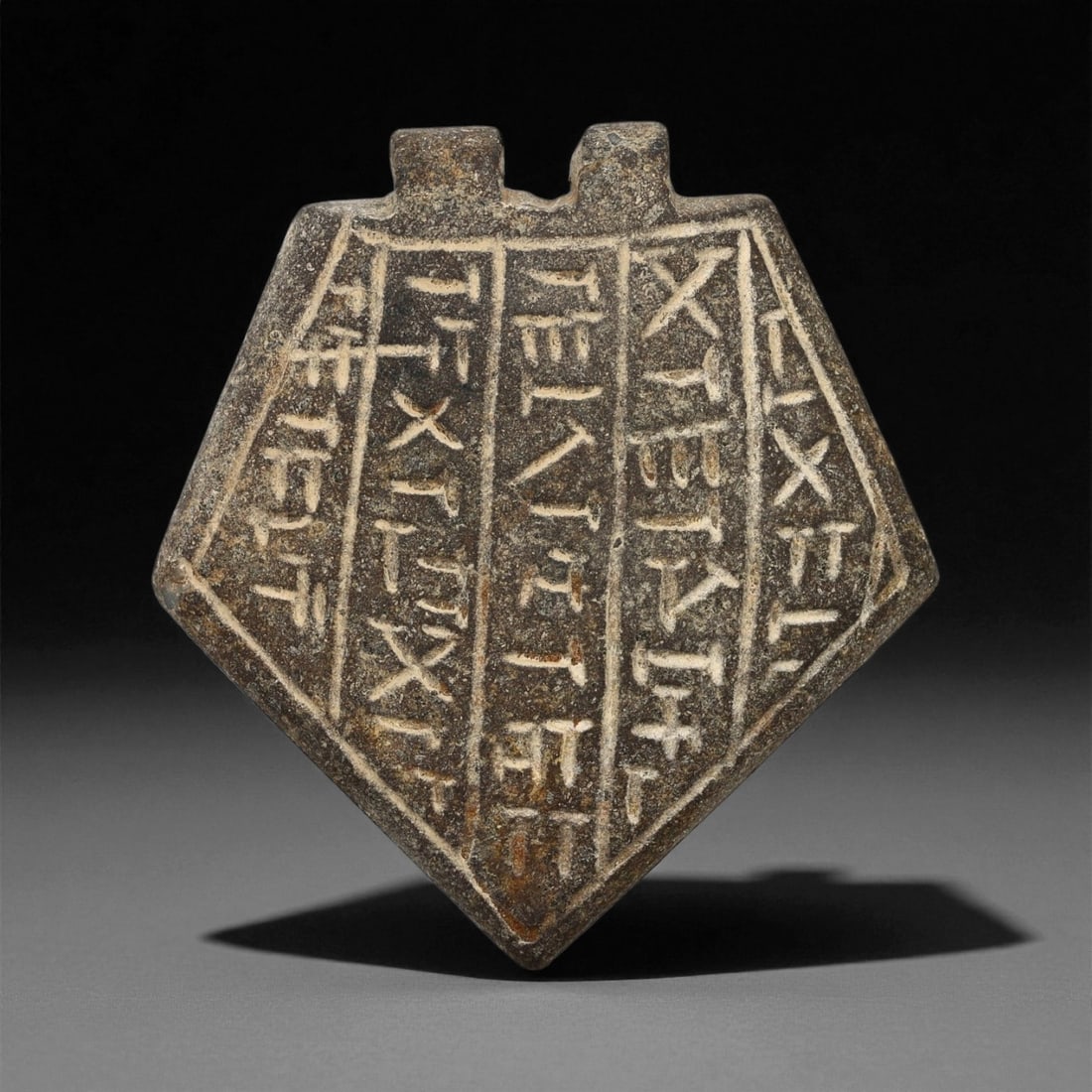 Ancient Mesopotamian Inscribed Serpentine Amulet, c. Neo-Assyrian Period, 5.3cm, 61ES: This finely inscribed serpentine amulet, dating to the Neo-Assyrian period (circa 9th-7th century BCE), exemplifies the spiritual sophistication and artistic precision of Mesopotamian protective magic