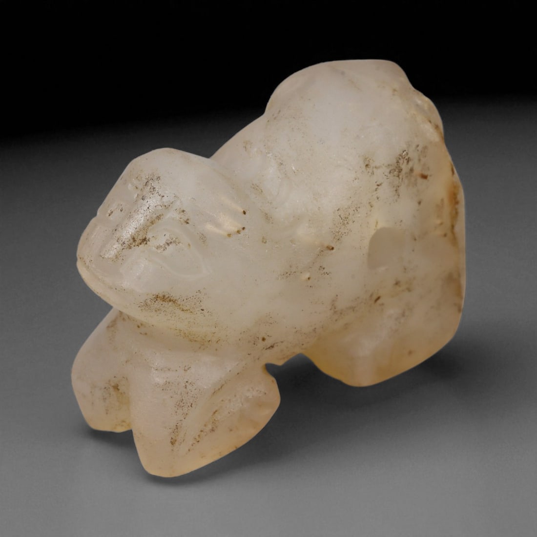 Ancient Bactrian Feline Amulet in Alabaster Stone, c. 2200-1800 BCE, 4 cm, 38BF: This compact amulet, carved in the form of a crouching feline, originates from the ancient Bactrian region-modern northern Afghanistan and southern Central Asia-during the Bronze Age. Crafted from fin