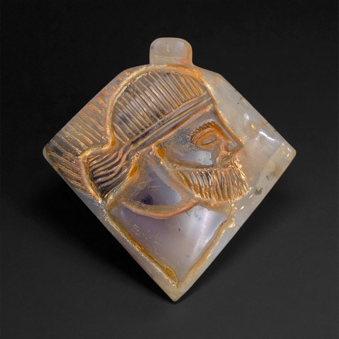 Ancient Parthian Chalcedony Portrait Amulet, c. 1st Century BCE-1st Century CE, 5.5cm, 65g, 100DD: This remarkable chalcedony amulet from the Parthian Empire displays a finely carved male portrait rendered in profile, its dignified expression and intricate detailing testifying to the exceptional la
