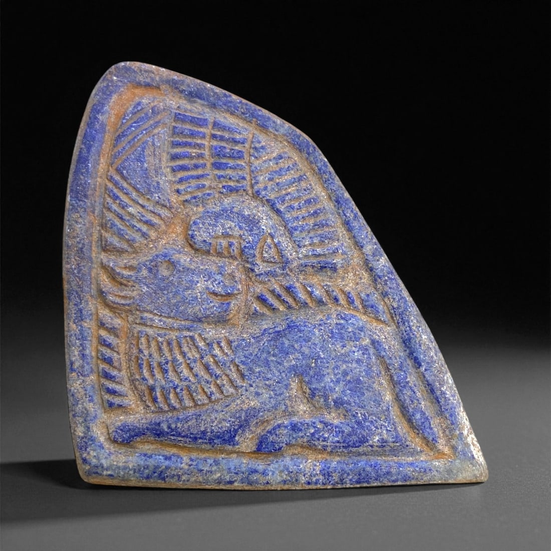 A Near Eastern Revivalist Lapis Lazuli Sacred Bull Plaque, c. 18th-19th Century, 9cm, 101g, 60CC: This exquisite plaque, carved from solid lapis lazuli, exemplifies the Near Eastern revivalist tradition of the 18th-19th century, a period when artisans sought to revive the splendor and symbolism of