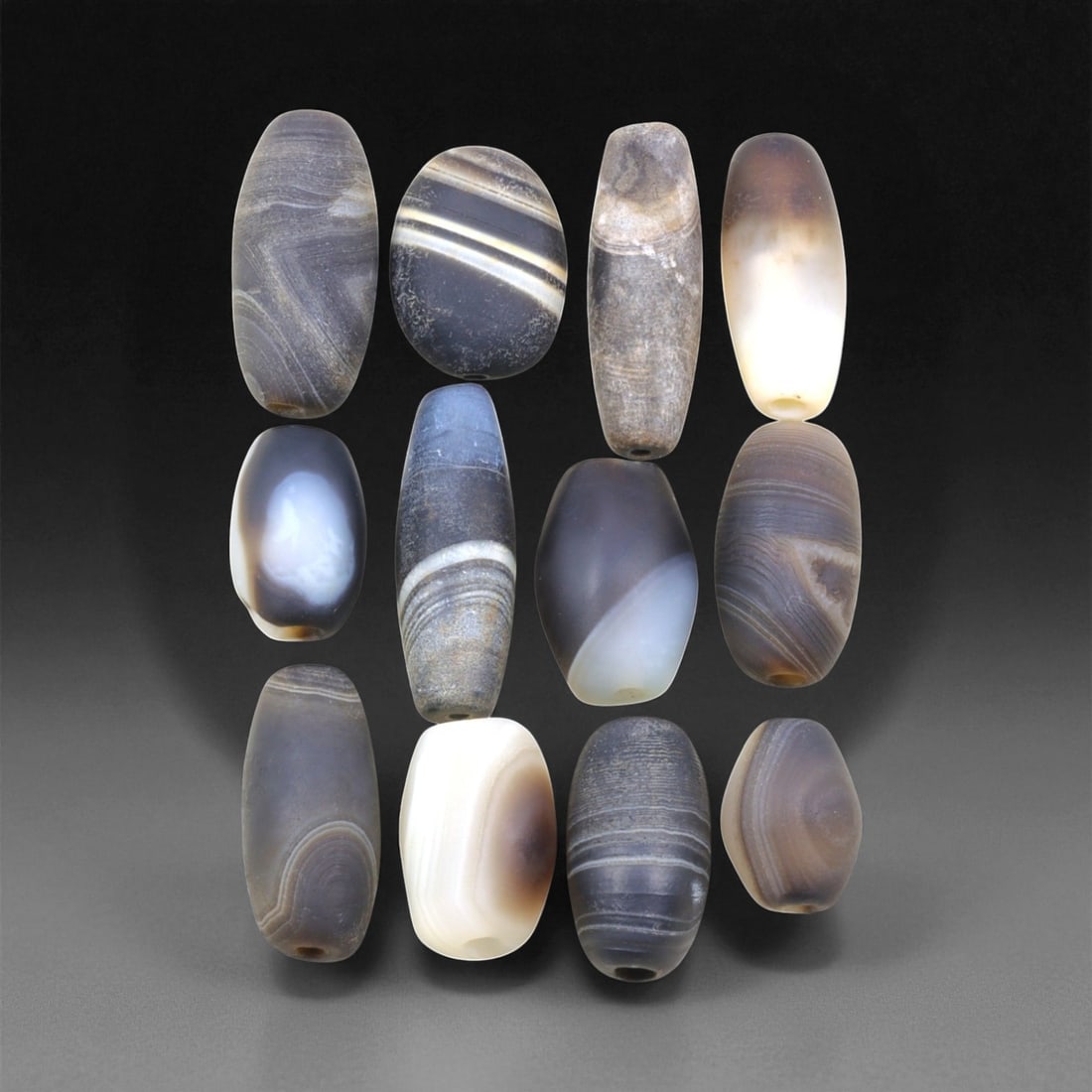Ancient Medieval Sulaimani Agate Beads, c. 11th-14th Century CE, 1.5-2.7 cm, 19EL: This elegant group of Sulaimani agate beads originates from the Indo-Persian cultural sphere of the 11th-14th centuries CE, a period when trade and craftsmanship flourished across Central and South As