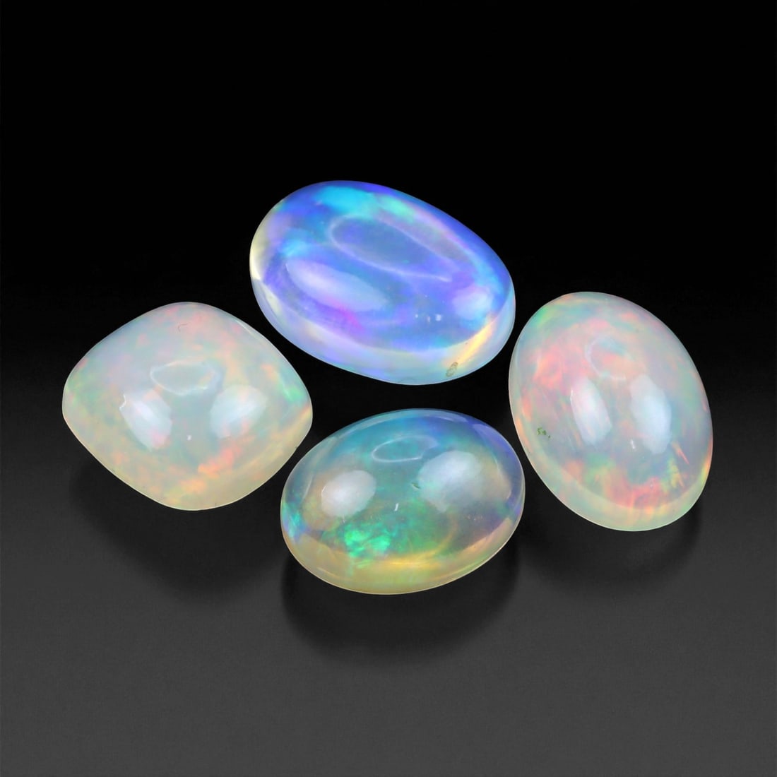 8.97 Carats Neon Play-of-Color Opal Selection - Natural Ethiopian Cabochons - 9 to 11 mm, 68XE: This luminous selection of opals radiates a dynamic spectrum of neon hues, with flashes of electric green, vivid orange, and spectral blue dancing across each dome. Their translucent base allows the i