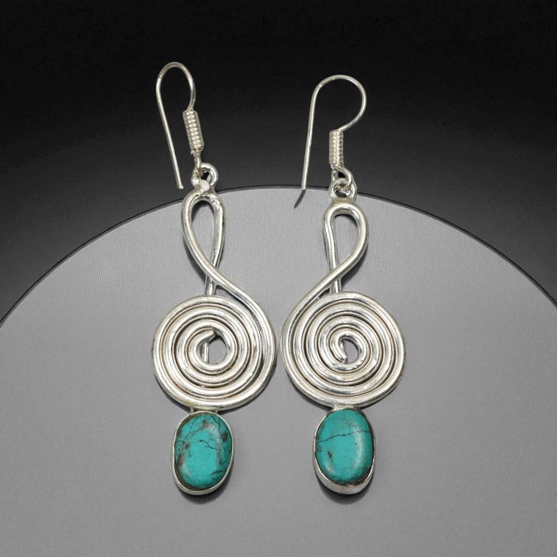 Tibetan Spiral Symbol Turquoise Drop Silver Earrings, Himalayan Artisan Design, 10g, 77K: These elegant Tibetan earrings combine minimalist form with ancient symbolism through their spiral silver structure and turquoise drop stones. The coiled silver wire forms a central spiral-an enduring