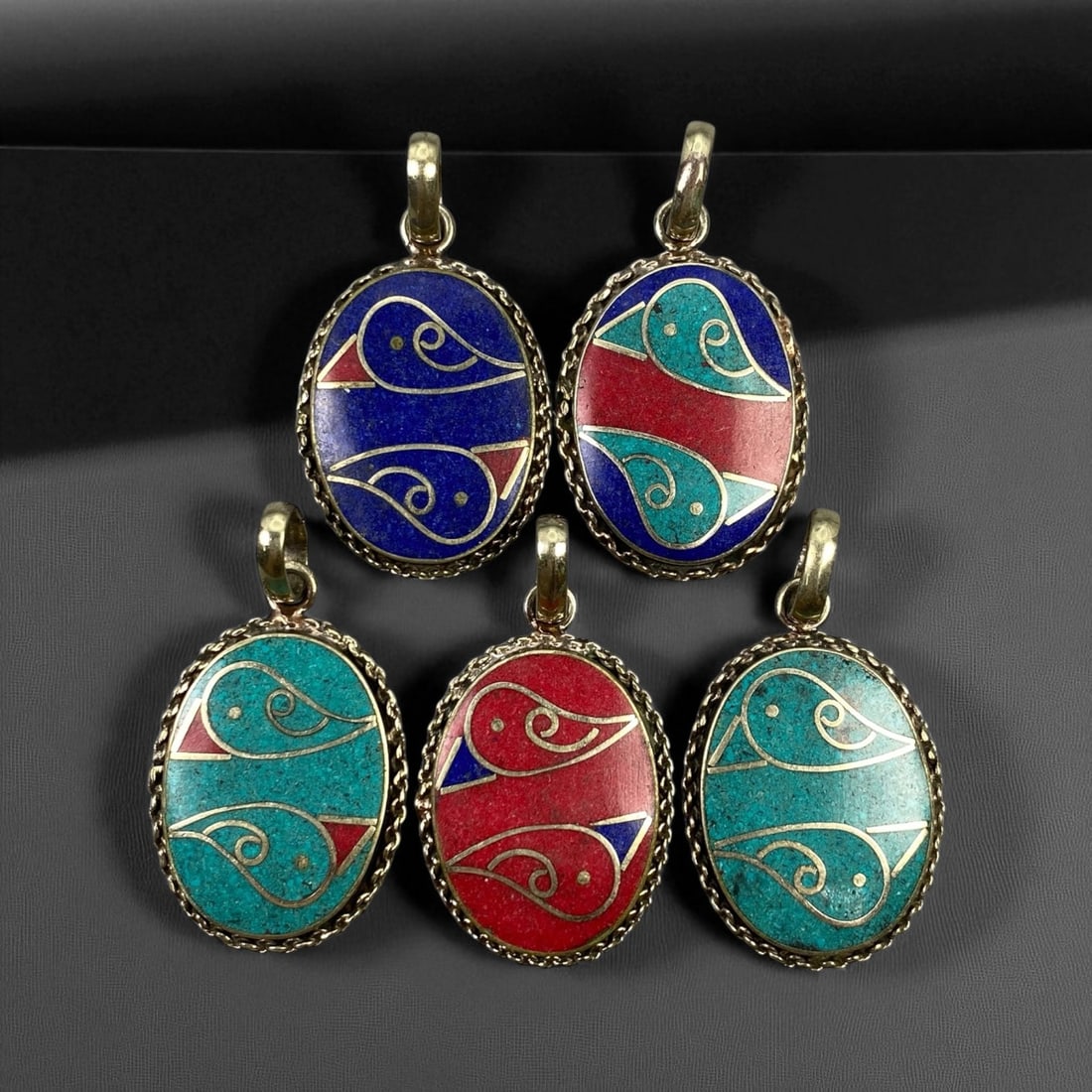 Vintage Himalayan Tribal Pendants, Lot of 5, c. 20th Century, 3-4 cm, 95DA: These vintage Himalayan pendants capture the spirit and artistry of traditional jewelry from the highlands of Tibet and Nepal. Crafted with vibrant inlay work and detailed metal framing, they exemplif