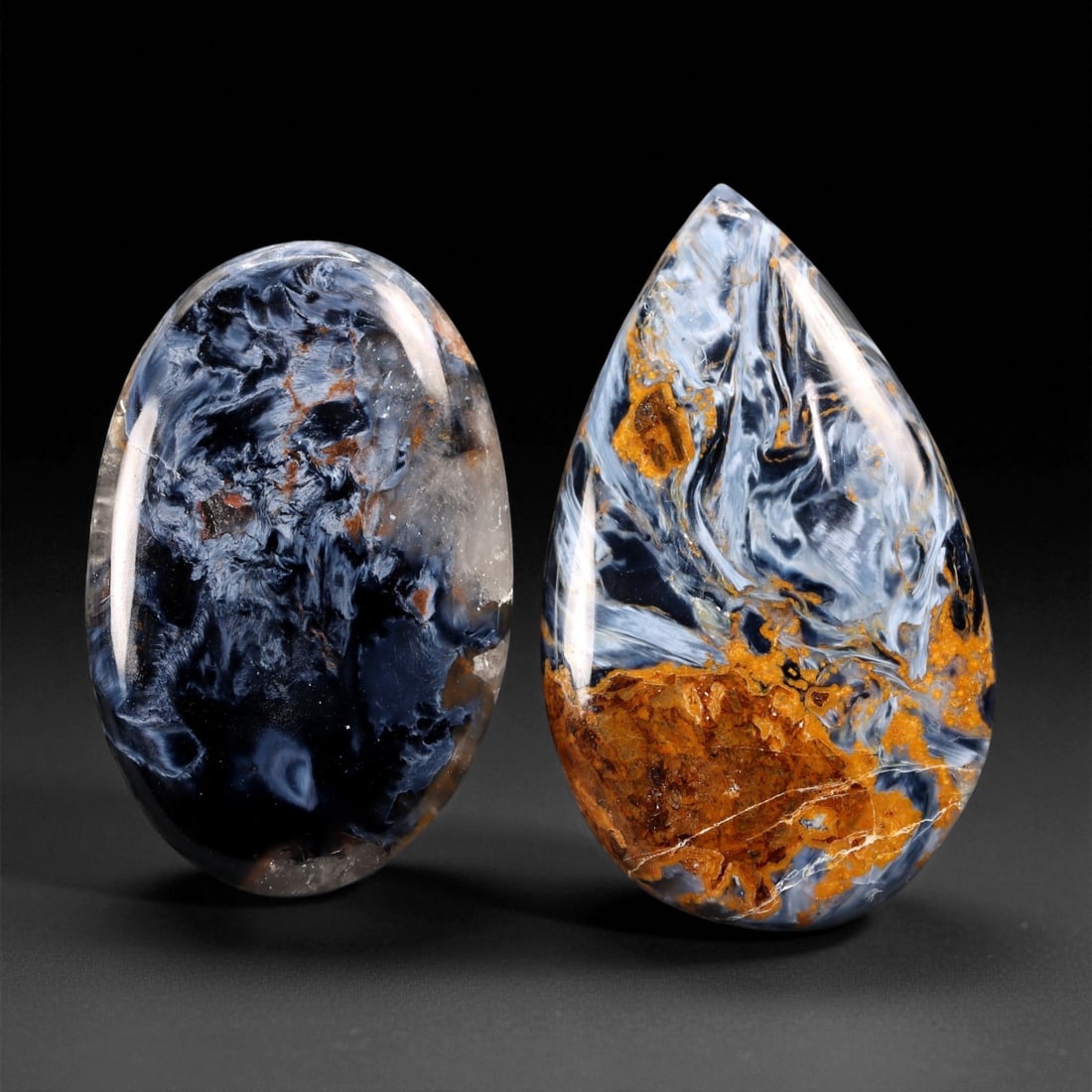 62.63 Carats Stormy Blue Pietersite Cabochon Pair - Natural Oval & Teardrop, 3.4 x 2 cm, 71XE: This mesmerizing pair of Pietersite cabochons displays the stone's signature storm-like beauty-swirling clouds of midnight blue, slate gray, golden ochre, and smoky quartz. The fibrous chatoyancy in t