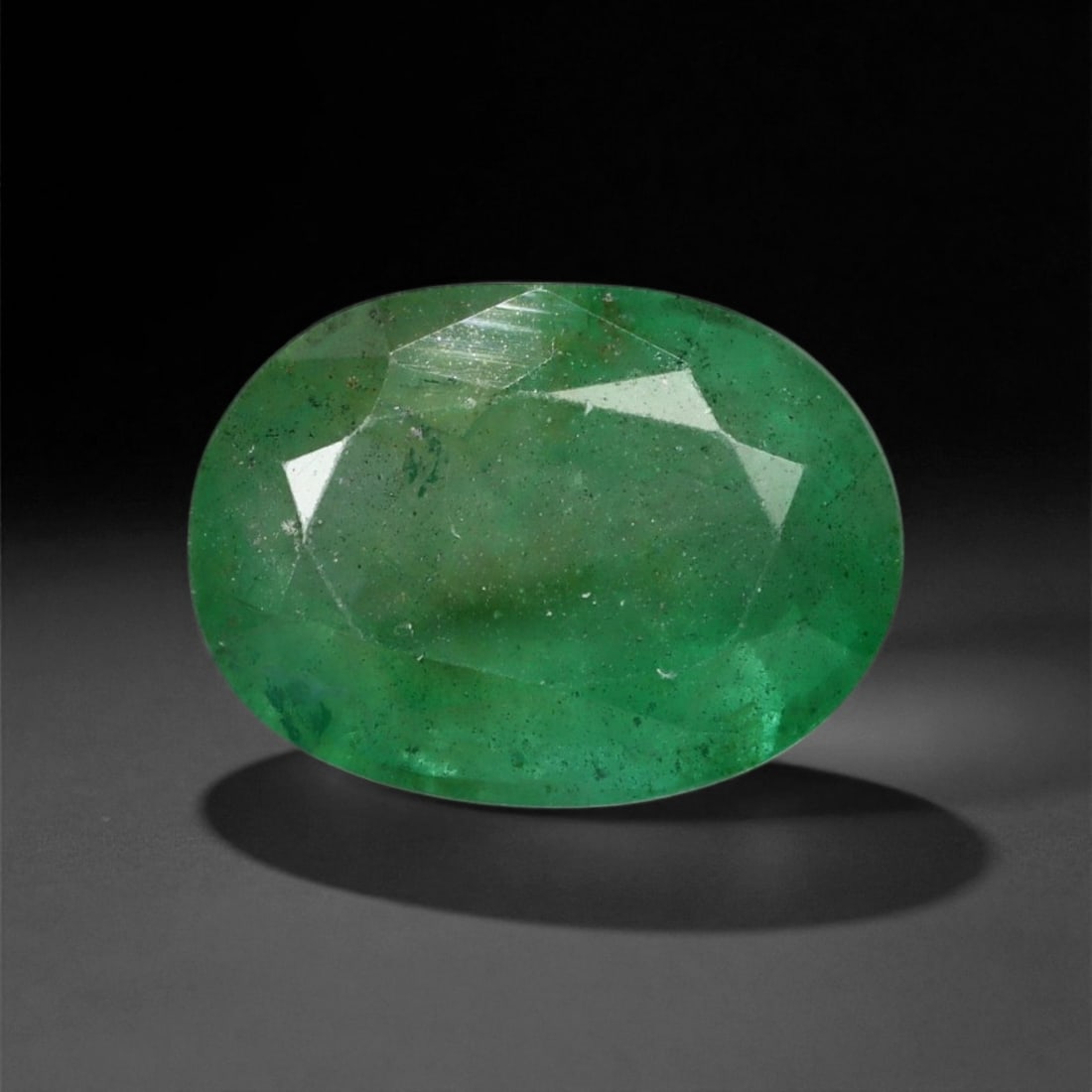 2.63 Carats Rich Green Emerald Oval - Natural Zambian Stone - 10.5 x 7.9 mm, 7XE: This deeply saturated emerald reveals a vivid green tone with a slightly bluish undertone, displaying the strength and brightness characteristic of Zambian material. The gem features a broad oval face