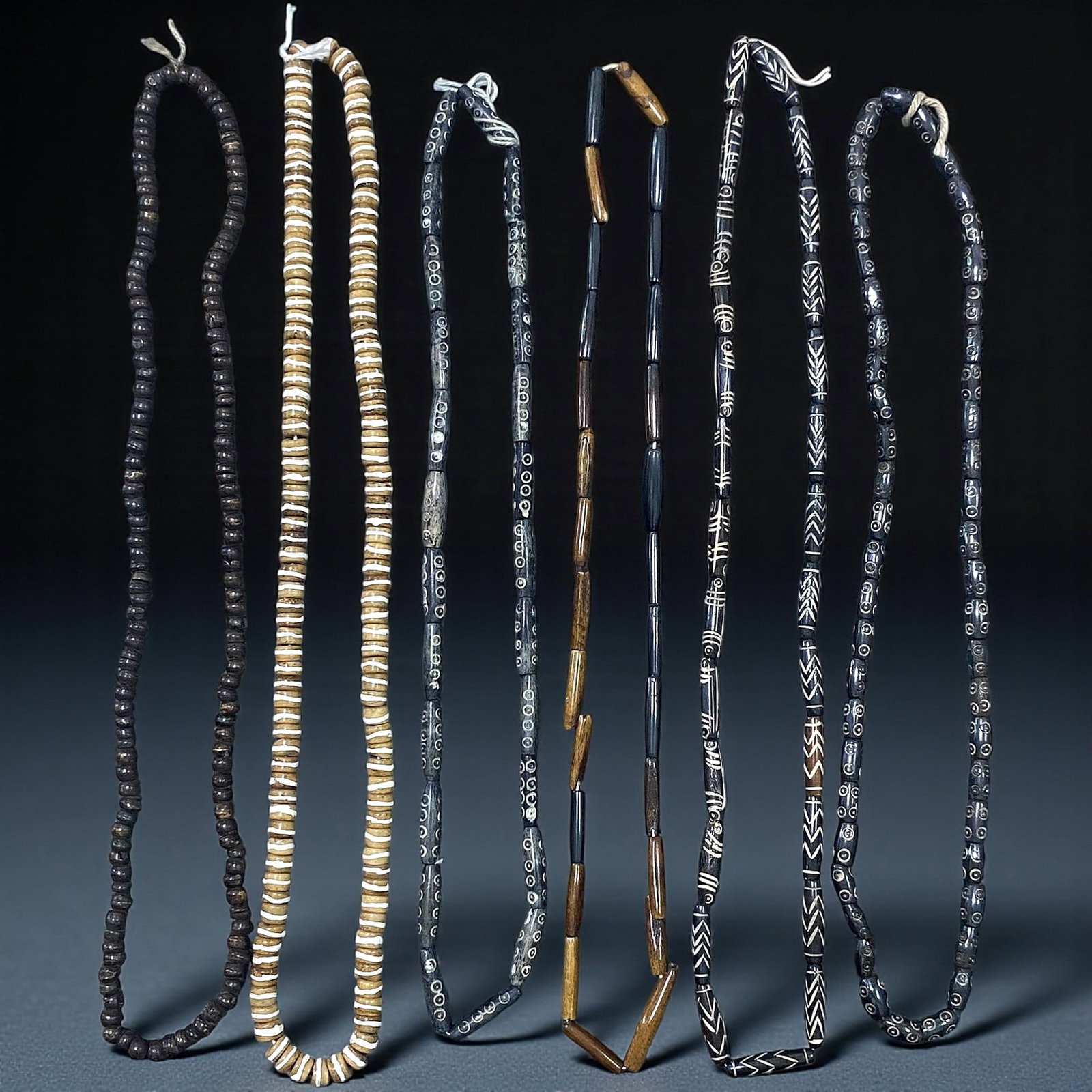 Vintage Himalayan Etched Bone and Wood Prayer Bead Strands, c. 20th Century, 6 Strands, 64EX: This collection of six vintage Himalayan bead strands showcases the region's enduring tradition of crafting devotional ornaments from organic materials. Dating to the 20th century, the assemblage incl
