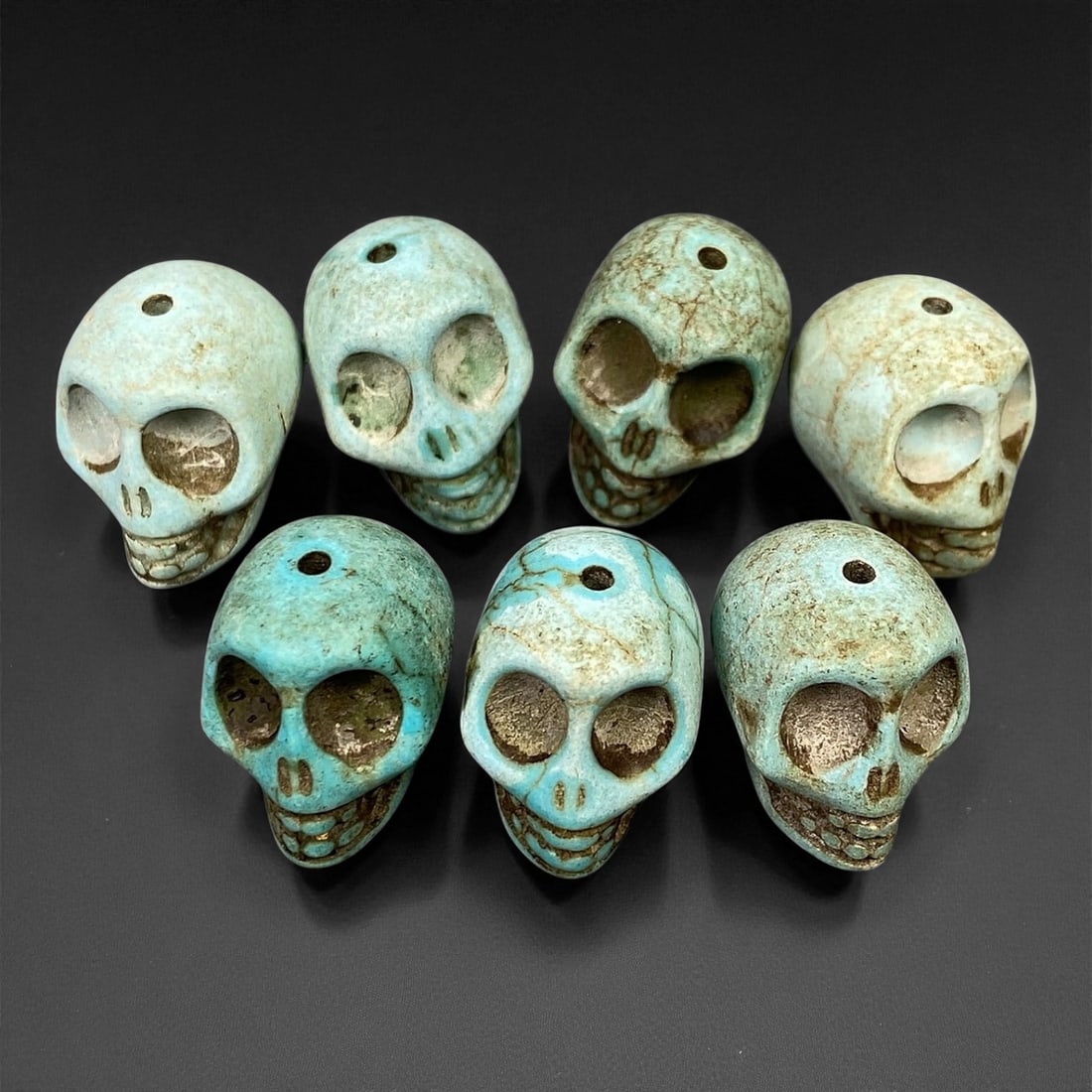 Vintage Tibetan Turquoise Skull Beads, Set of Four, c. Mid-20th Century, 1.7cm, 58C: This striking set of turquoise-carved skull beads, originates from Tibet and dates to the mid-20th century. Finely shaped and perforated for stringing, each bead represents a human skull, a motif rich