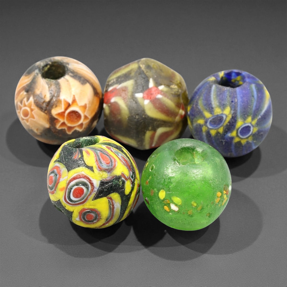 Antique Venetian Millefiori Trade Glass Bead c. 19th Century 1.6-1.7cm, 52ET: This antique Venetian trade glass bead reflects the vibrant millefiori artistry perfected in 19th century Murano workshops, where layered canes were shaped into richly patterned forms for distribution