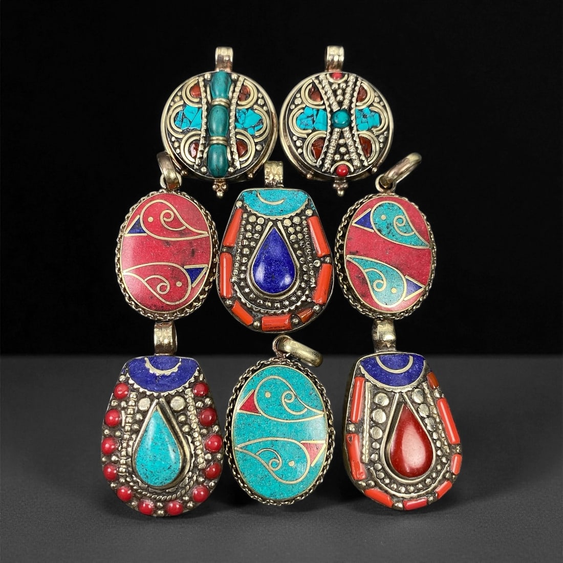 Vintage Himalayan Tribal Pendants, Lot of 8, c. 20th Century, 3-4 cm, 66ES: These vintage Himalayan pendants capture the spirit and artistry of traditional jewelry from the highlands of Tibet and Nepal. Crafted with vibrant inlay work and detailed metal framing, they exemplif