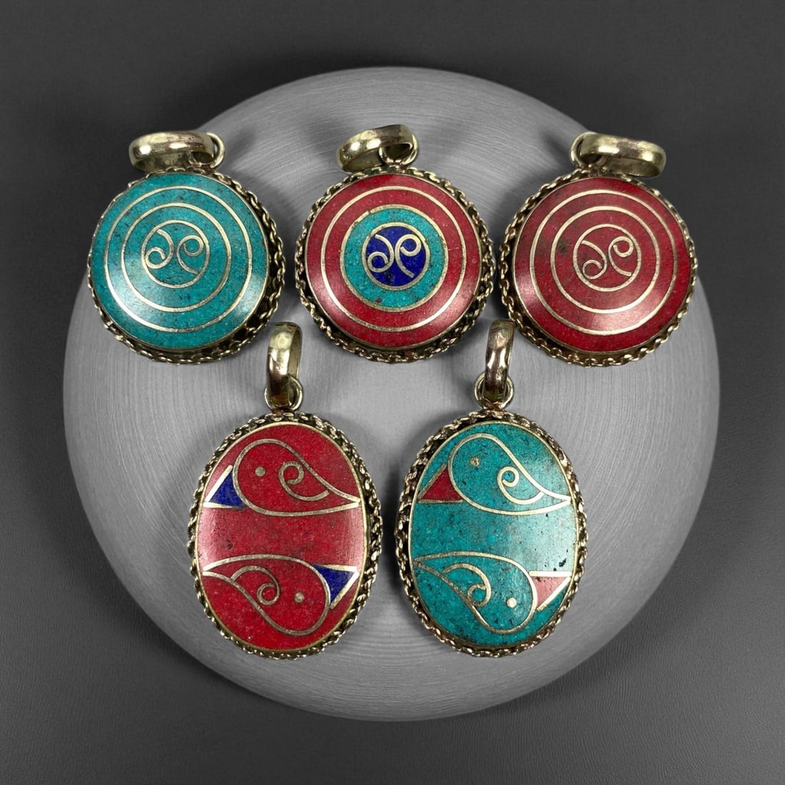 Vintage Himalayan Tribal Pendants, Lot of 5, c. 20th Century, 3-4 cm, 89DA: These vintage Himalayan pendants capture the spirit and artistry of traditional jewelry from the highlands of Tibet and Nepal. Crafted with vibrant inlay work and detailed metal framing, they exemplif