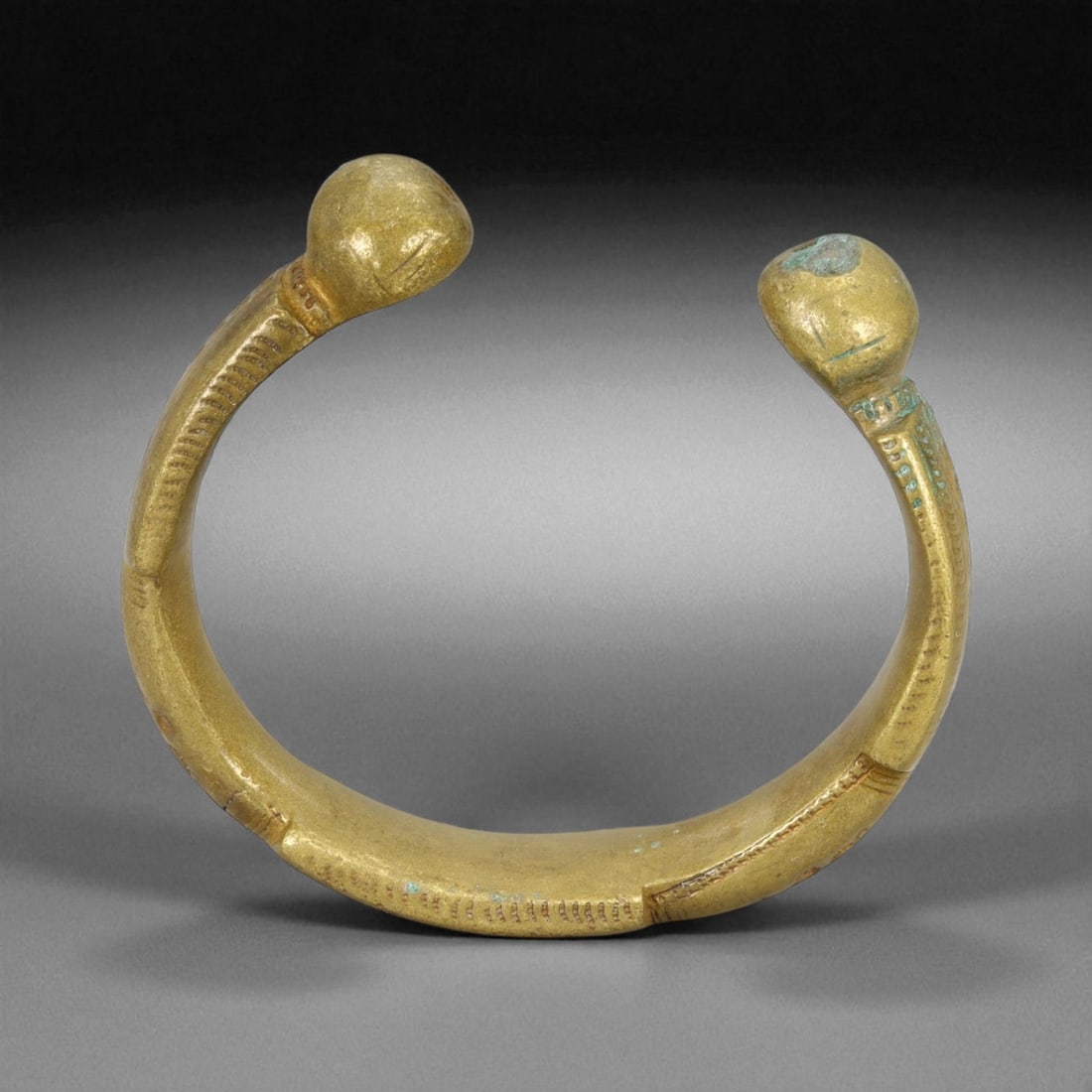 A West African Royal Manilla Currency Bracelet Symbolic Bronze Form, 19th Century, 8cm, 172g, 86Q: This powerful A currency bracelet, known as a manilla, originates from West Africa and dates to the 19th century. Heavy, closed-ended forms like this were often used not only in trade but also as symb