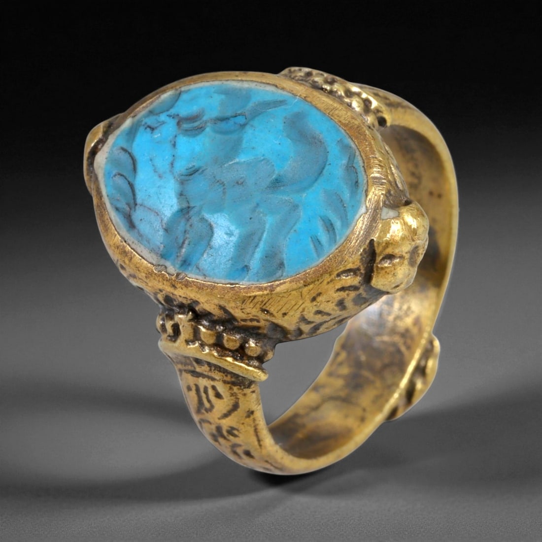 Antique Qajar Gold Gilt Intaglio Signet Ring, c. 19th-20th Century, 9 US, 13g, 85EQ: This substantial gilt ring, dating to the Qajar era of the 19th-20th century, embodies the regal aesthetic and cultural refinement of Persian jewelry traditions. The bezel is set with an engraved inta