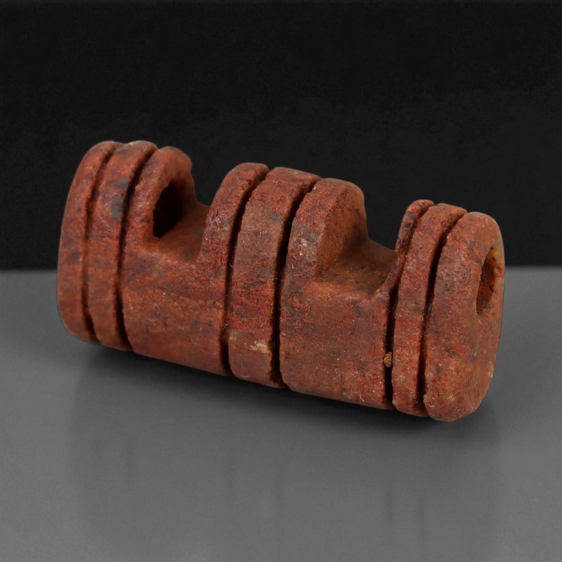 Ancient Persian Red Jasper Amulet, Achaemenid Period, c. 6th-4th Century BCE, 2.2cm, 84CS: This striking red jasper amulet, dating to the Achaemenid Persian period (c. 6th-4th century BCE), is a superb example of early lapidary craftsmanship fused with spiritual intent. Carved in a geometri