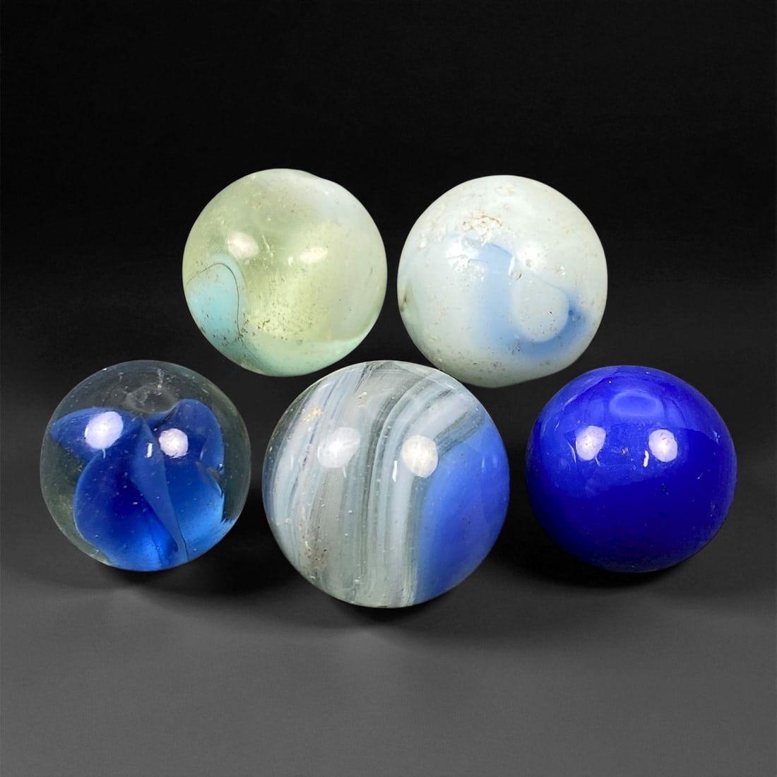Vintage Glass Marbles Lot, Mid-20th Century, 1.4-1.6cm, 30EN: This charming lot of vintage glass marbles, dating from the mid-20th century, reflects the artistry and playfulness of early handmade and molded glass craftsmanship. These marbles were produced during