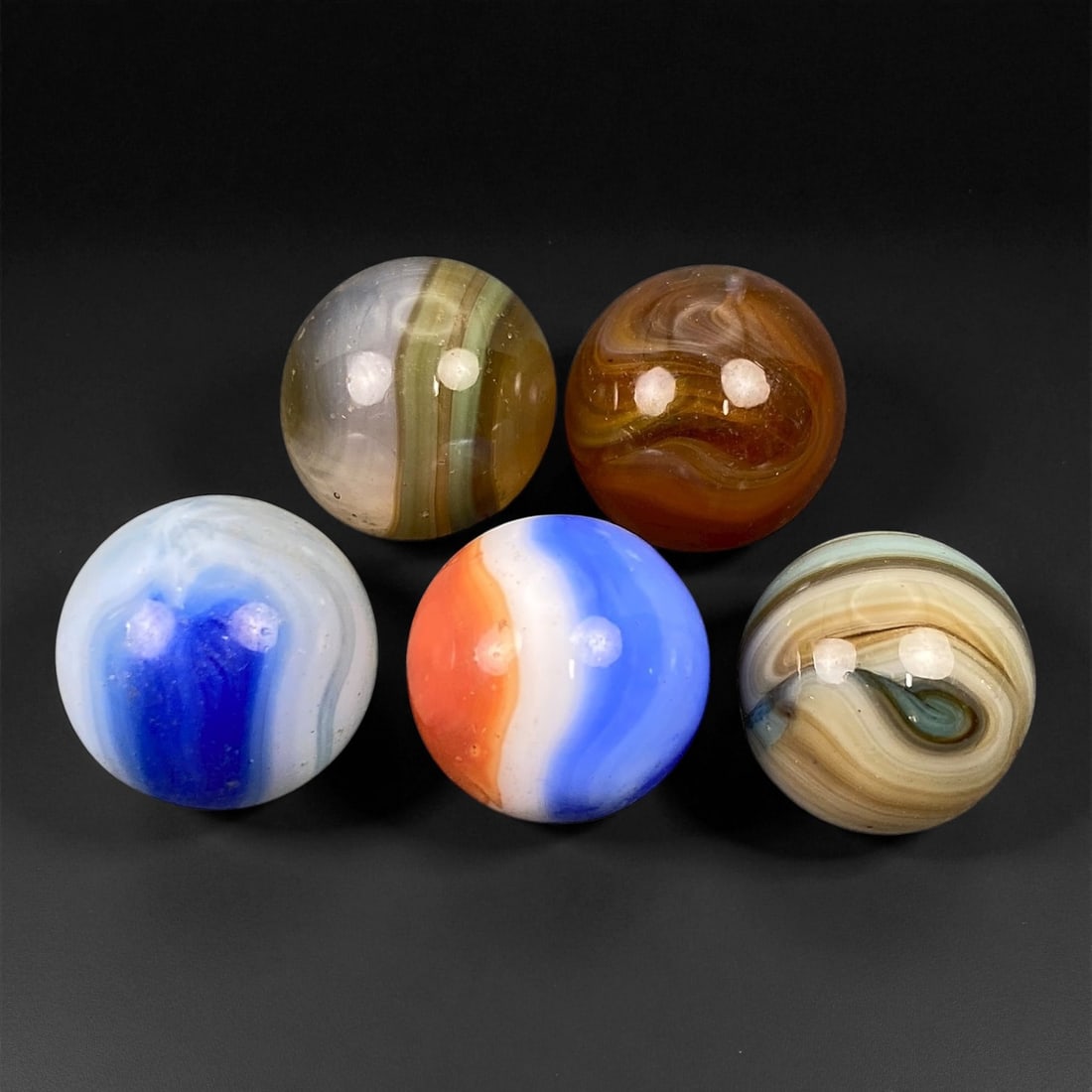Vintage Glass Marbles Lot, Mid-20th Century, 1.4-1.5cm, 40EK: This charming lot of vintage glass marbles, dating from the mid-20th century, reflects the artistry and playfulness of early handmade and molded glass craftsmanship. These marbles were produced during