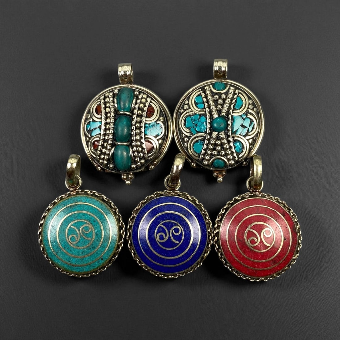 Vintage Himalayan Tribal Pendants, Lot of 5, c. 20th Century, 3-4 cm, 22DA: These vintage Himalayan pendants capture the spirit and artistry of traditional jewelry from the highlands of Tibet and Nepal. Crafted with vibrant inlay work and detailed metal framing, they exemplif