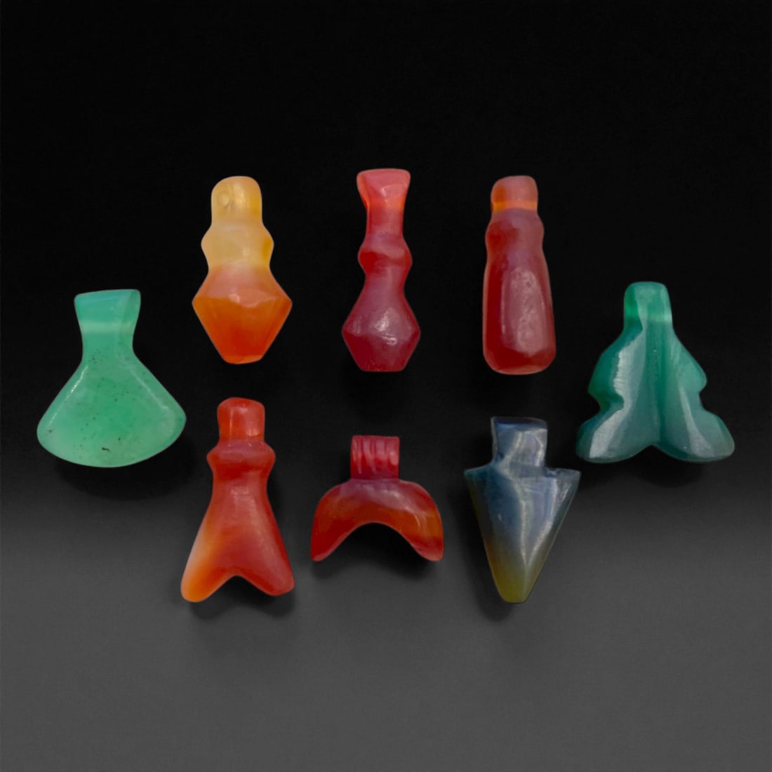 A Coptic Egyptian Carnelian and Green Chalcedony Amulets, c. 4th-7th Century CE, 1-1.7cm, 8g, 31DD: This fine set of eight Coptic Egyptian amulets represents the sacred artistry of Late A Egypt, when the Coptic Christian community continued the millennia-old custom of wearing protective charms imbue