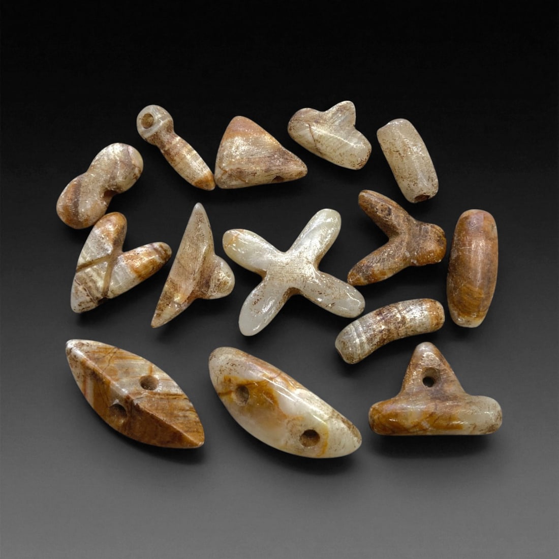 Ancient Chalcedony and Agate Beads & Amuletic Relics, c. 3rd-2nd Millennium BCE, 27g, 2-3cm, 47AA: This evocative assemblage of ancient beads and amuletic relics, carved from banded chalcedony and agate, reflects the aesthetic and spiritual sensibilities of early Bronze Age civilizations across Mes