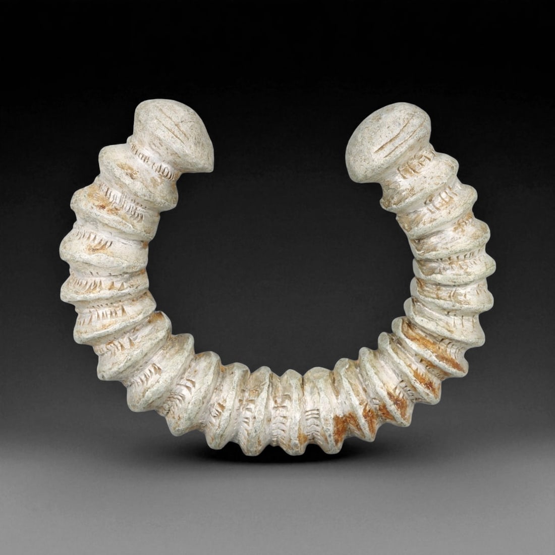 A West African Spiral Form Cast Aluminum Currency Bracelet, Early 20th Century, 8.5cm, 101g, 73Q: This striking A bracelet, cast in aluminum and designed in an exaggerated spiral form, represents the evolving tradition of currency adornment in early 20th-century West Africa. This piece stands out 