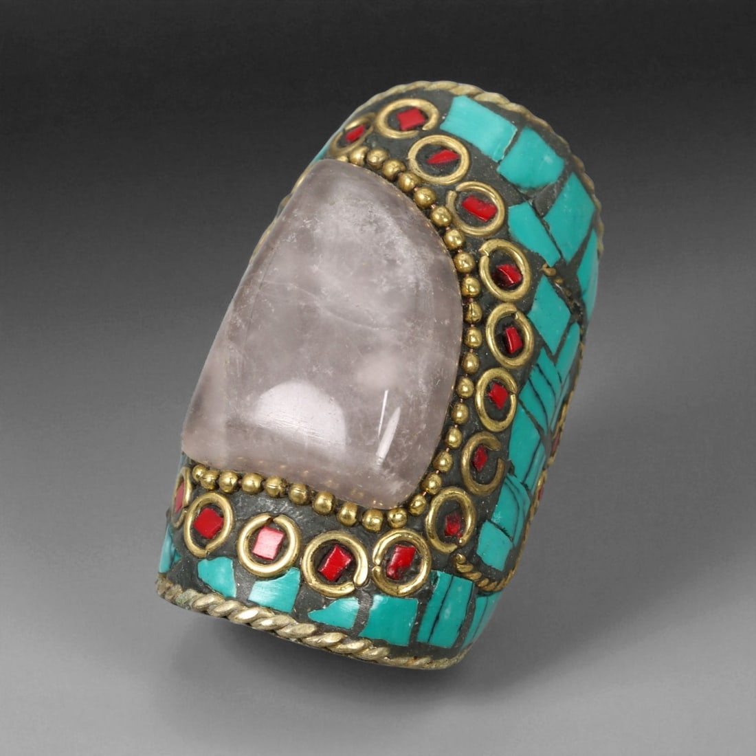 Vintage Himalayan Tribal Rose Quartz Turquoise Coral Brass Ring, 20th Century, US Size 8, 7XD: This magnificent vintage Himalayan ring exemplifies the rich spiritual and artistic legacy of Himalayan craftsmanship, uniting natural stones and symbolic design in an exquisite statement piece. The r