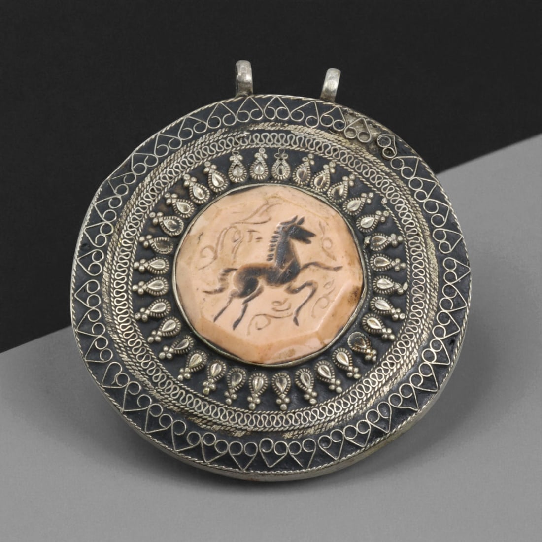 Antique Persian Silver Pendant with Horse Motif, 117g, 60Z: This Persian pendant captures the dynamic spirit of the horse, a powerful and recurring symbol in Persian culture associated with strength, nobility, and freedom. At its center lies a warm beige stone